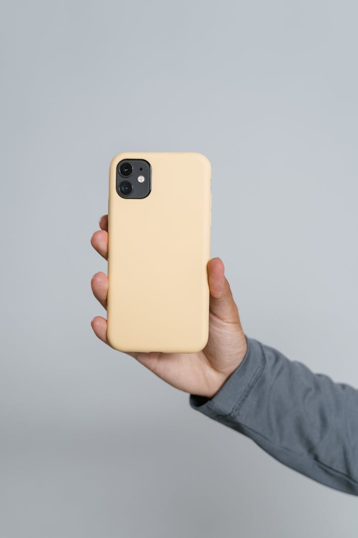 Person Holding Yellow Iphone Case